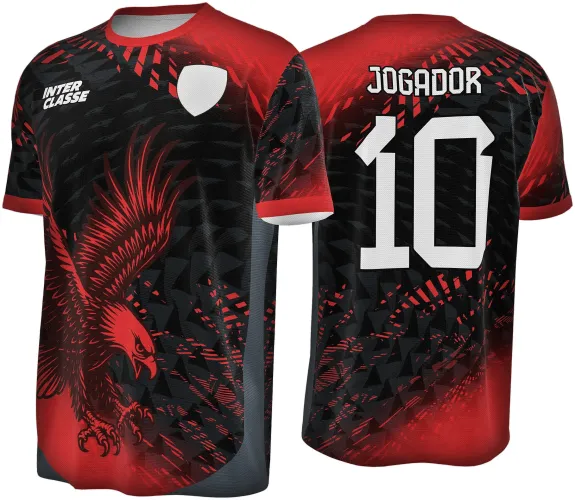 Camisa com águia vermelha em pose agressiva na frente, fundo preto com padrões geométricos em vermelho e cinza. Costas com texto 'JOGADOR' e número 10 em branco, com degradê vermelho no topo.