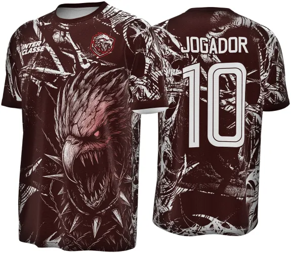 Camisa vinho com arte frontal de águia sombria vermelha e branca exibindo expressão feroz; nas costas, número 10 e texto JOGADOR em branco sobre fundo vinho com detalhes em branco.