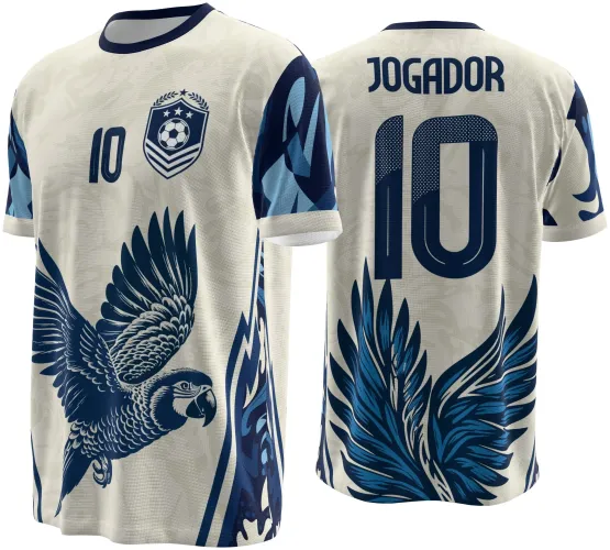 Camisa com fundo bege, arara azul voando na frente, escudo com bola e estrelas e número 10 azul no peito. Atrás, nome JOGADOR e grande número 10 azul escuro com detalhes de penas azuis.