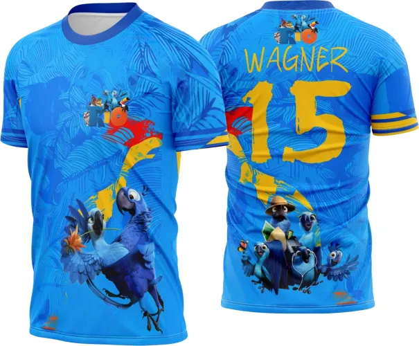 Camisa azul vibrante com duas araras azuis na frente e texto 'RIO'. Nas costas, grupo de araras em diversas poses, nome WAGNER amarelo acima do número 15. Mangas com faixas amarelas destacam a estampa tropical.
