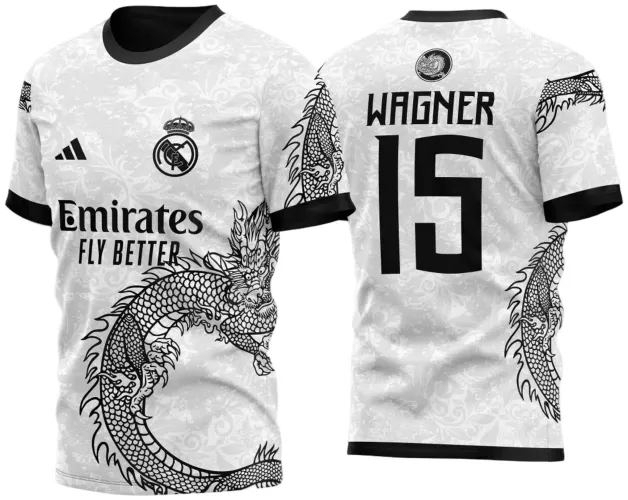 Camisa branca com estampa de dragão preto envolvente na frente e mangas, nome WAGNER e número 15 em preto nas costas, fundo com detalhes flora cinza claro, gola e punhos pretos, texto Emirates FLY BETTER e logos na frente.