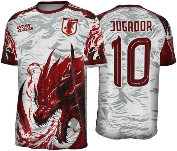 Camisa com dragão vermelho agressivo e detalhado na frente, fundo branco com cinza em ondas, mangas vermelhas com detalhes pretos, costas com nome JOGADOR e número 10 em vermelho escuro, frente com escudo JFA e texto INTER CLASSE.