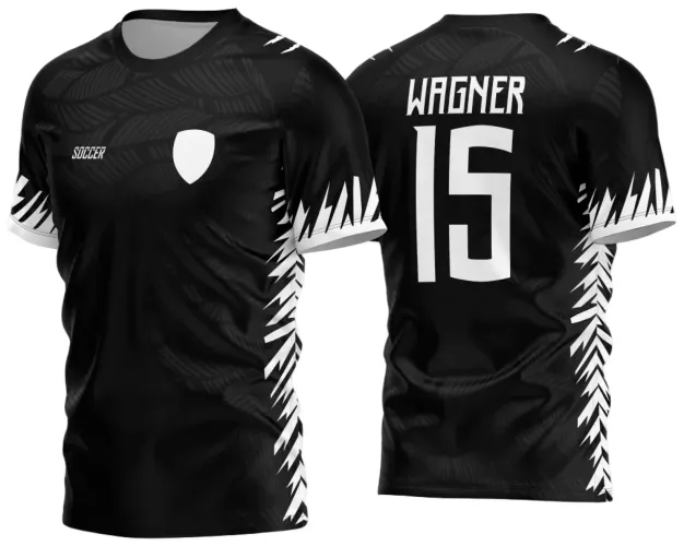 Camisa preta com padrão de folhas brancas nas laterais e mangas, escudo branco no peito, texto 'SOCCER' à direita na frente, nome WAGNER e número 15 em branco nas costas.