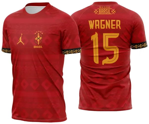 Camisa vermelha com padronagem geométrica na frente e atrás, frente com escudo da CBF, logo Jordan e 'BRASIL' em amarelo, mangas com faixas pretas decoradas, costas com nome 'WAGNER', número 15 e textos amarelos com detalhes gráficos.
