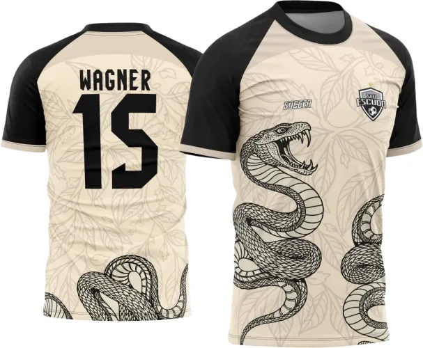 Camisa interclasse com fundo bege decorado com folhas claras e cobra preta enrolada na frente e parte inferior das costas; mangas pretas com punhos em bege; textos 'SEU ESCUDO', 'SUGGER', 'WAGNER' e número '15' em preto destacam o design.