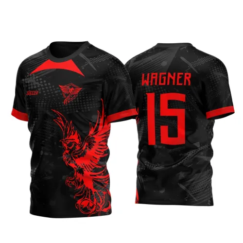 Camisa preta com detalhes em cinza e vermelho, frente com grande fênix vermelha e escudo no peito, texto 'SOCCER'; costas com nome 'WAGNER' e número 15 em vermelho, detalhes vermelhos nas mangas e colarinho.