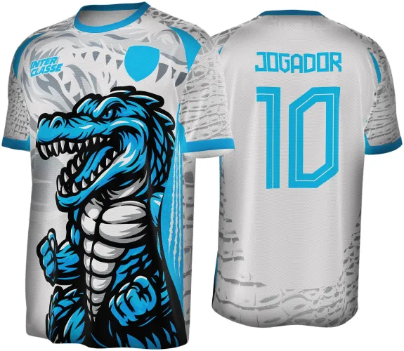 Camisa branca com crocodilo azul e branco na frente, texto azul INTER CLASSE e escudo azul, costas com o texto JOGADOR e número 10 em azul, detalhe de escamas cinza nas laterais e punhos azuis.