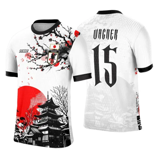 Camisa branca com estampa frontal de árvore de sakura e pagode em preto, detalhes em vermelho e escudo JFA. Costas com número 15 grande preto e nome WAGNER acima, mangas brancas com contorno preto.