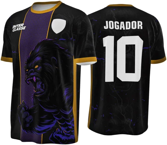 Camisa preta com faixa roxa central na frente, um gorila agressivo em roxo e amarelo ocupa a parte frontal. Nas costas, texto branco JOGADOR e número 10 em destaque. Mangas com borda amarela e fundo preto com detalhes roxos.