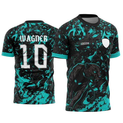 Camisa preta com padrão turquesa, mostra uma pantera negra em pose de ataque na frente, texto 'SOCCER' e escudo em branco; atrás, nome 'WAGNER' e número 10 em branco com contorno preto, fundo com manchas turquesa