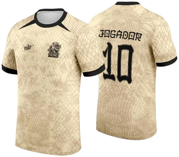 Camisa bege com padrão geométrico, leão dourado na frente com texto TERCEIRÃO, gola e punhos em preto, número 10 e palavra JOGADOR em preto nas costas.