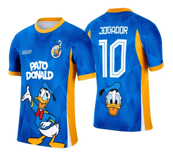 Camisa azul com detalhes laranja na gola e laterais, frente com Pato Donald em pose alegre e texto branco PATO DONALD, costas exibem nome JOGADOR e número 10 em branco com cabeça do Pato Donald na parte inferior.