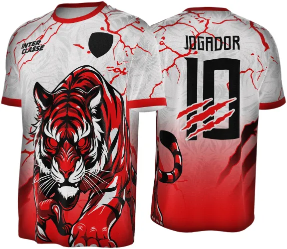 Camisa com grande tigre vermelho em posição de ataque na frente, fundo branco com rachaduras vermelhas e gola vermelha. Costas com o nome JOGADOR, número 10 e marcas de garras em vermelho sobre fundo com degradê branco para vermelho.
