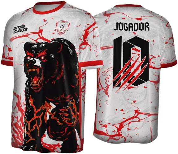 Camisa com estampa de urso preto atacando na frente, detalhes em vermelho e laranja, fundo branco com manchas vermelhas; nas costas, número 10 com garras vermelhas e texto JOGADOR, além do mesmo padrão de fundo branco com vermelho.