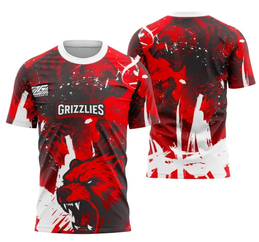 Camisa com arte frontal de urso vermelho feroz com detalhes pretos, texto GRIZZLIES no peito e fundo misto de vermelho, preto e branco; nas costas, urso em pose agressiva, com splashes de tinta branca e vermelha sobre fundo vermelho escuro.