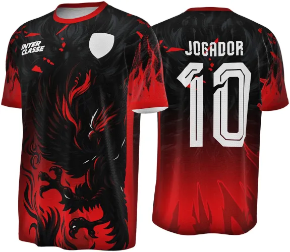 Camisa com degradê vermelho para preto, fênix em preto e vermelho na frente e escudo branco; costas com texto JOGADOR e número 10 em branco, além de detalhes vermelhos em formato de chamas.