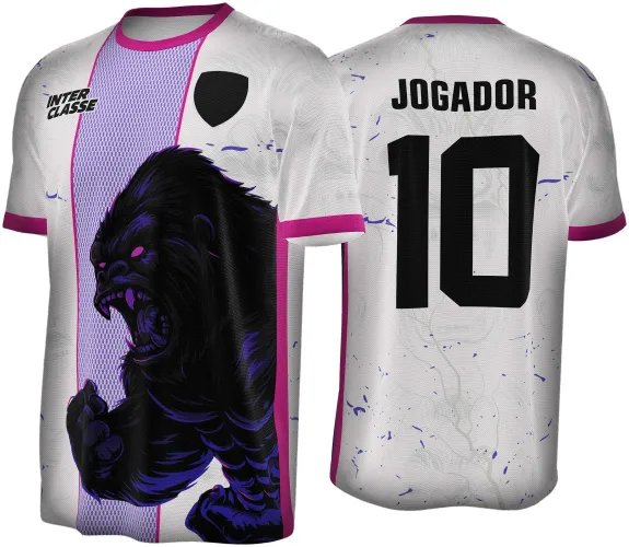 Camisa branca com detalhes rosa pink e faixa cinza texturizada na frente com ilustração agressiva de gorila preto e roxo, texto INTERCLASSE e escudo; nas costas, texto JOGADOR e número 10 em preto com detalhes roxos no fundo.