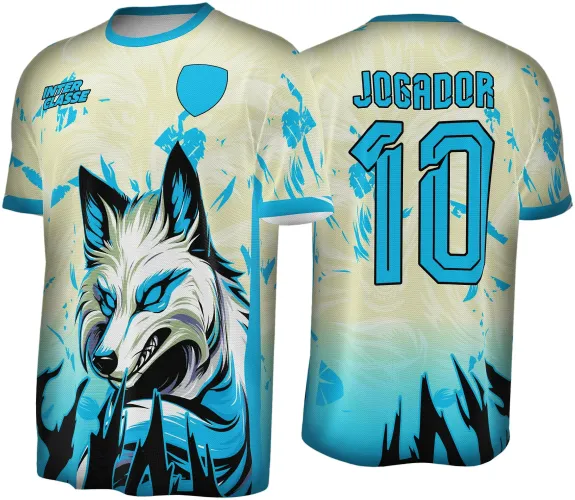 Camisa com frente em degradê creme para azul e raposa com olhos azuis e detalhes pretos. Escudo azul no peito direito e texto Inter Classe no esquerdo. Nas costas, número 10 e JOGADOR em azul com contorno preto sobre fundo creme e azul.